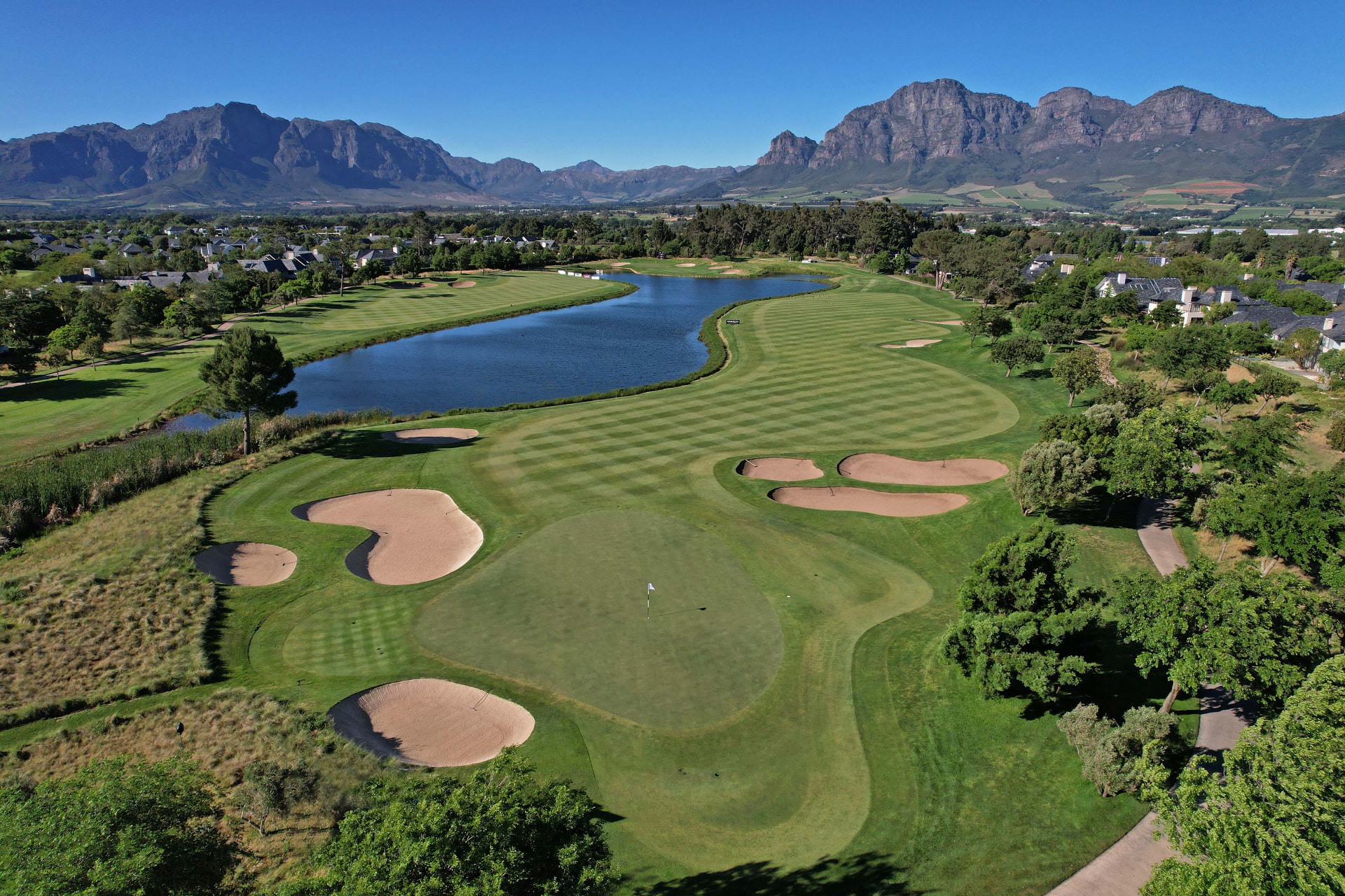 Aerial view of the Pearl Valley fairways and water beneath the Franschhoek Valley mountains