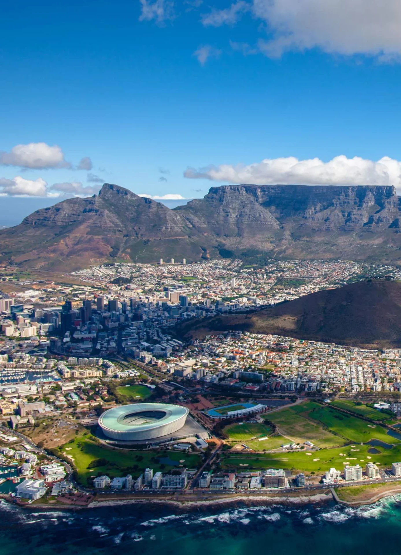 Aerial view over Cape Town with Table Mountain, the stadium and the Atlantic coastline