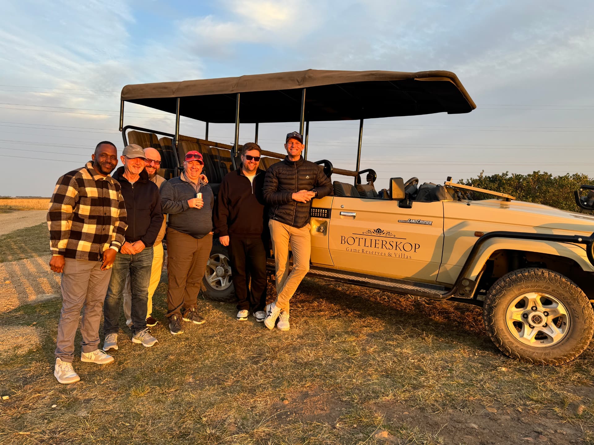 Golfers on a South African safari game drive at sunset
